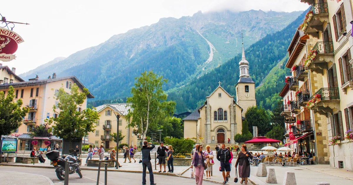 The main square of Chamonix with its church, hotels and mountains rising behind the town